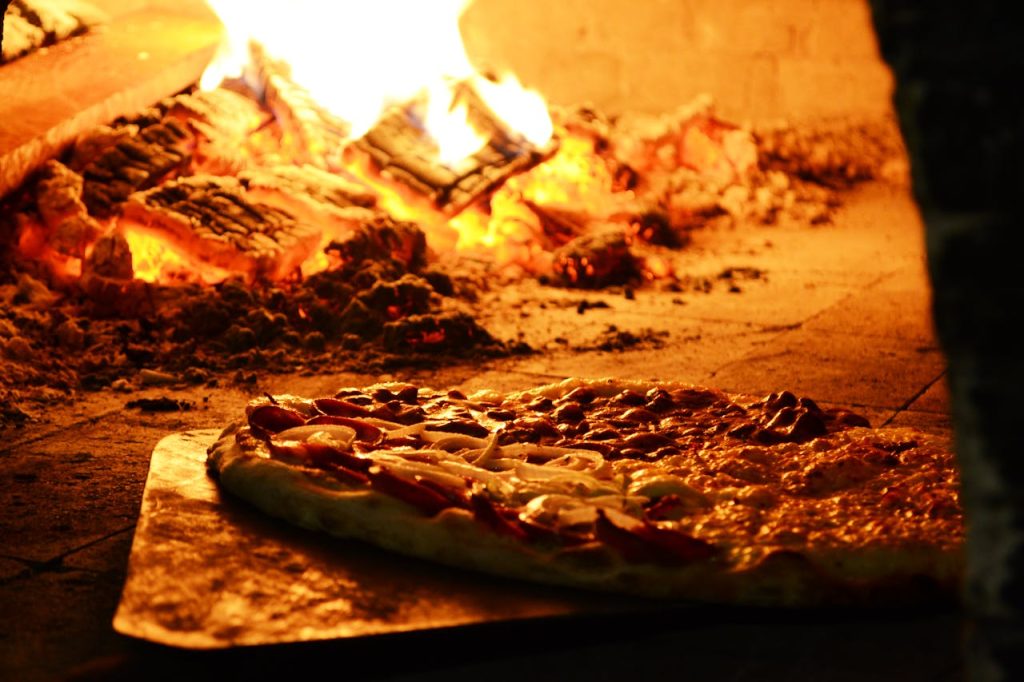 Mouthwatering pizza cooking in a traditional wood-fired oven, capturing the essence of Italian cuisine.